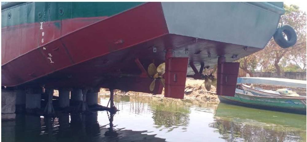 Orange dredger tug dry-docked for overhaul
